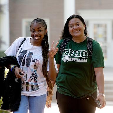 Two Ohio University students smile and pose