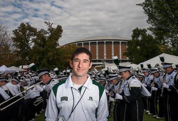 Gary Dillabaugh III poses for a portrait beside the Marching 110 performance during the Miami vs. OU football game tailgate party.  Photo by Elizabeth Held